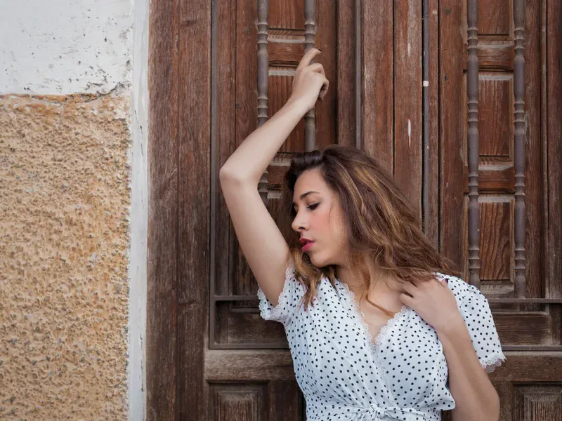 Girl next door at an old wooden door