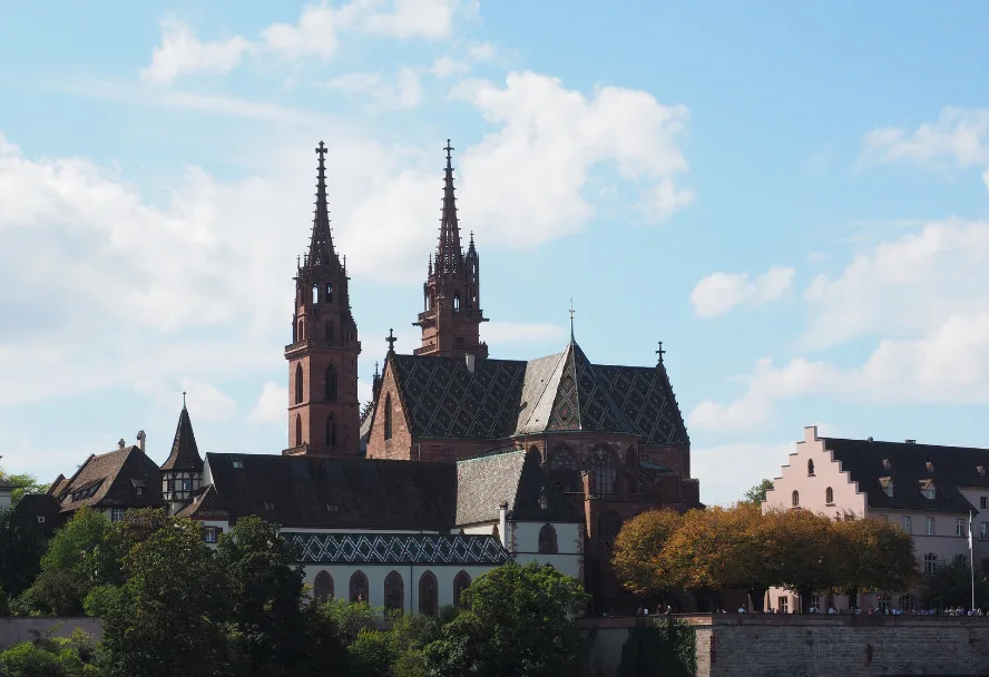 The towers of Basel Minster above the trees