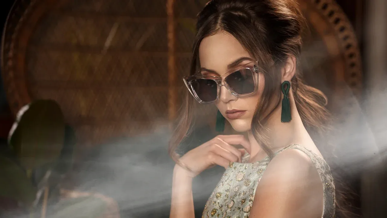 Escort lady in an evening dress looking out from a balcony over the rooftops