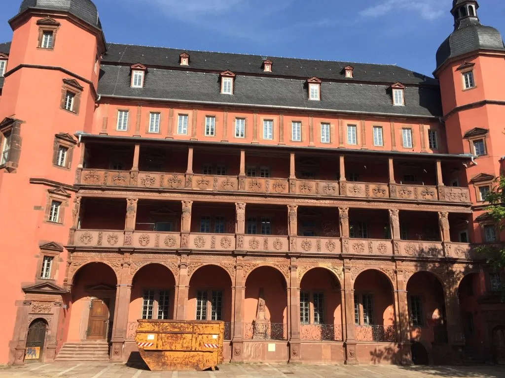The red arcaded courtyard of the Isenburg Palace in Offenbach in sunlight