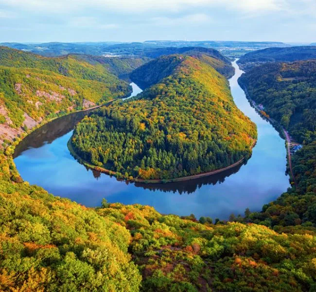 The Saar loop in autumn, the river in a tight bend between wooded slopes