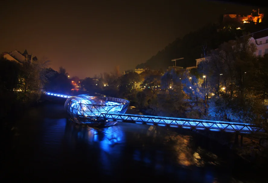 The Murinsel lit blue on the river at night
