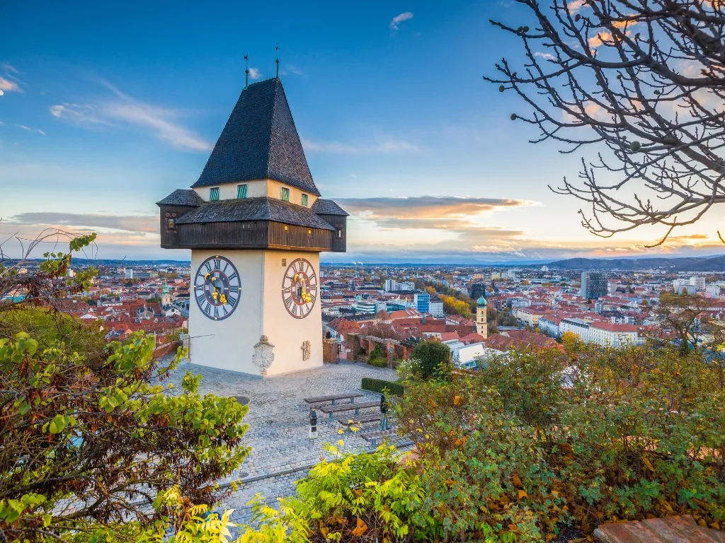 The clock tower on the Schlossberg above the roofs of Graz