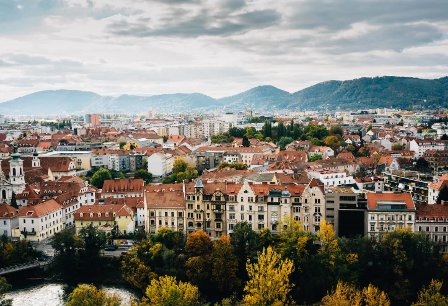 View over the roofs of Graz from the Schlossberg, the mountains on the horizon