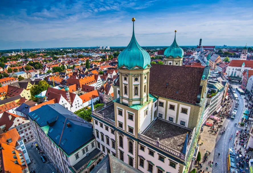 The tower of an Augsburg church above the rooftops of the old town
