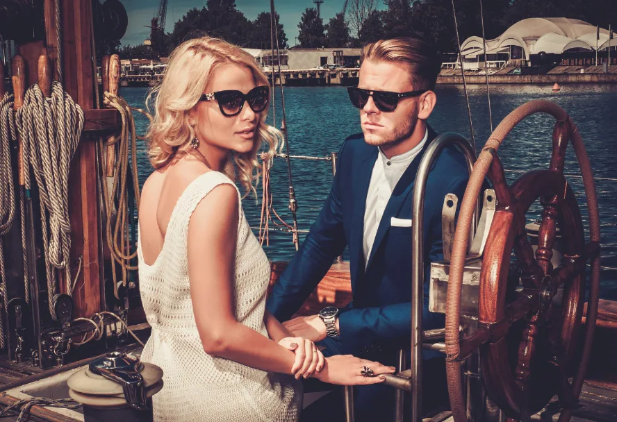 High class escort with a man on a yacht