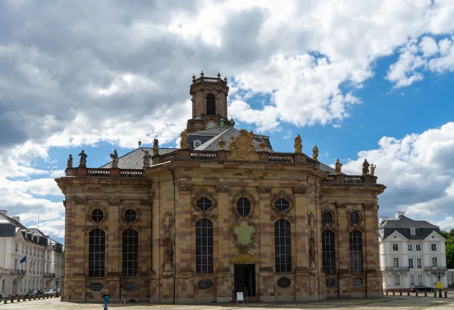 The baroque Ludwigskirche in pale sandstone on the Ludwigsplatz against a cloudy sky