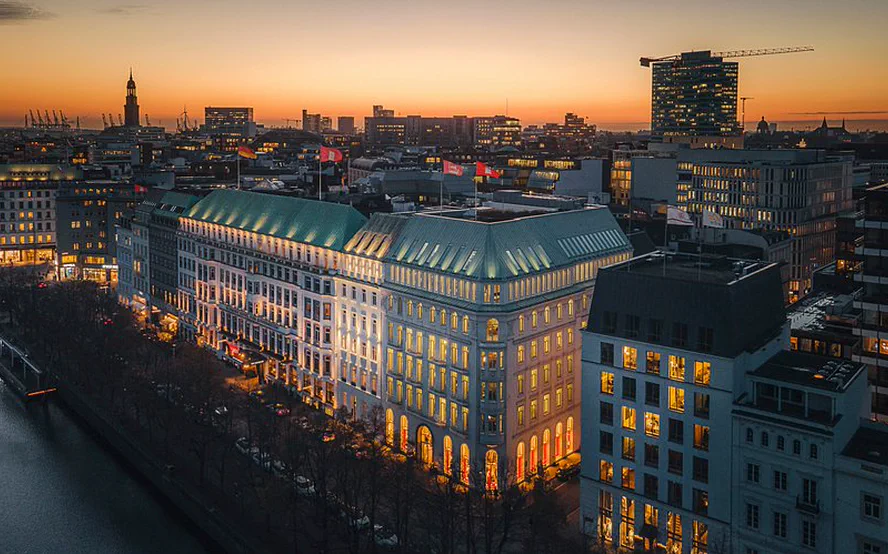 The grand hotel on the Neuer Jungfernstieg from above in the evening light, the Michel on the horizon to the left