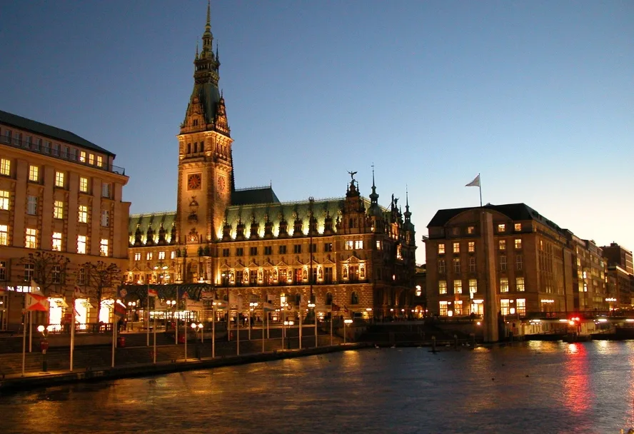 Hamburg town hall at night, mirrored in the Kleine Alster
