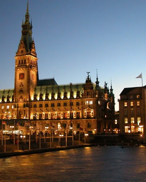 Hamburg town hall at night, mirrored in the Kleine Alster
