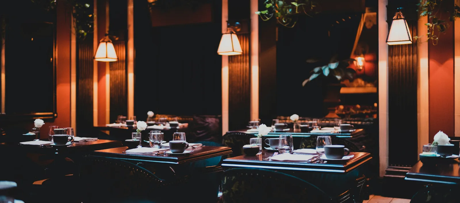 Laid tables in a warmly lit restaurant in the evening