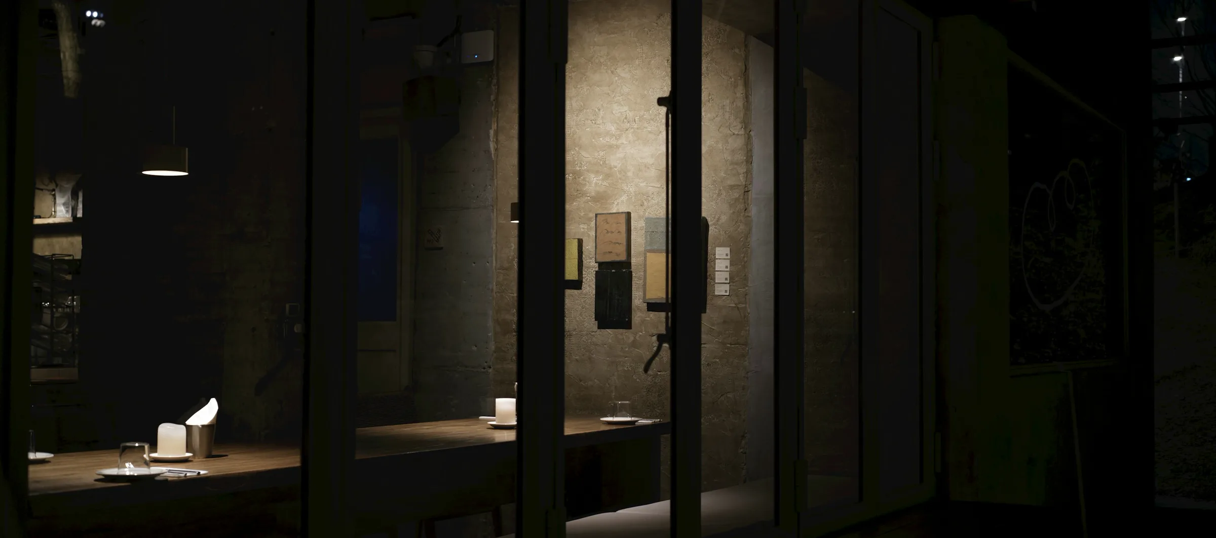 Ein privat gedeckter Tisch hinter Glas, abends
